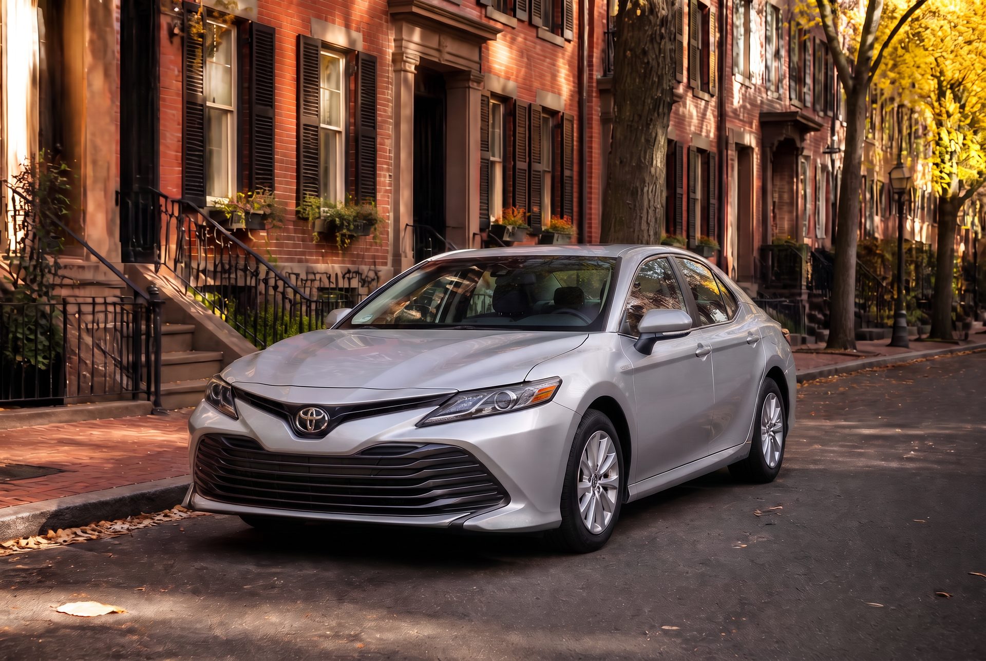 Silver sedan parked on a Boston brownstone street